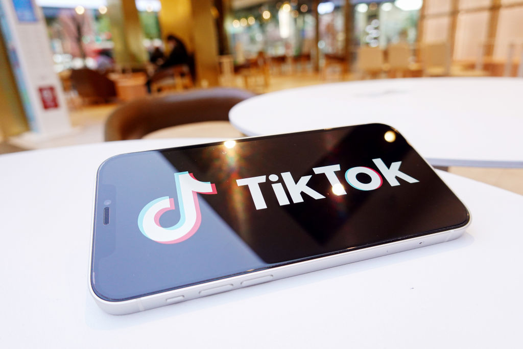 In this photo illustration, a Tiktok logo is displayed on...